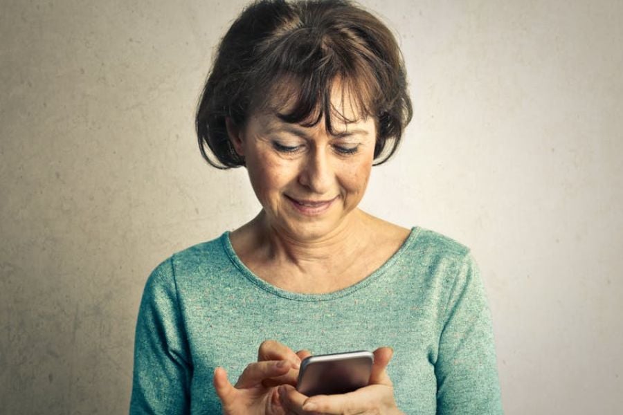 elderly woman looking at phone