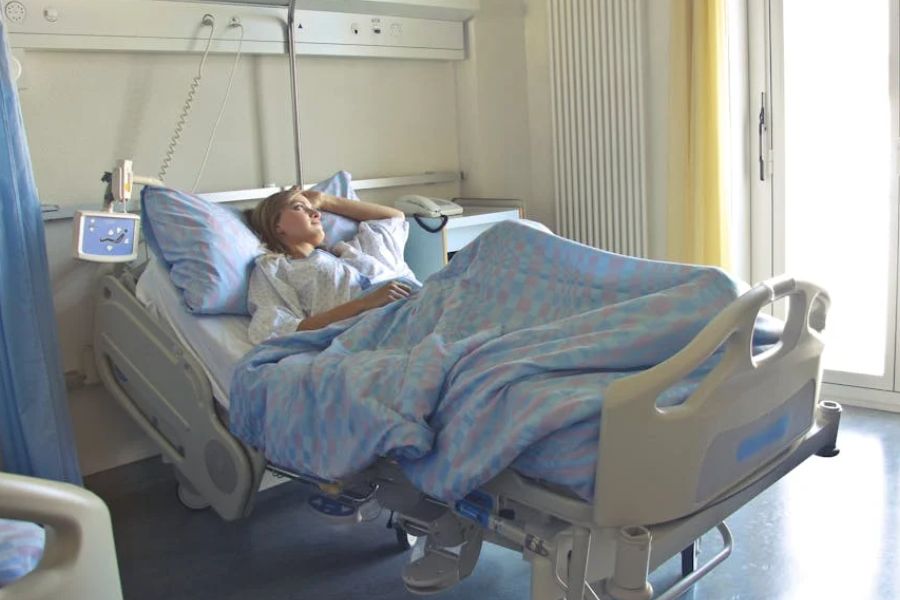 woman laying on a hospital bed