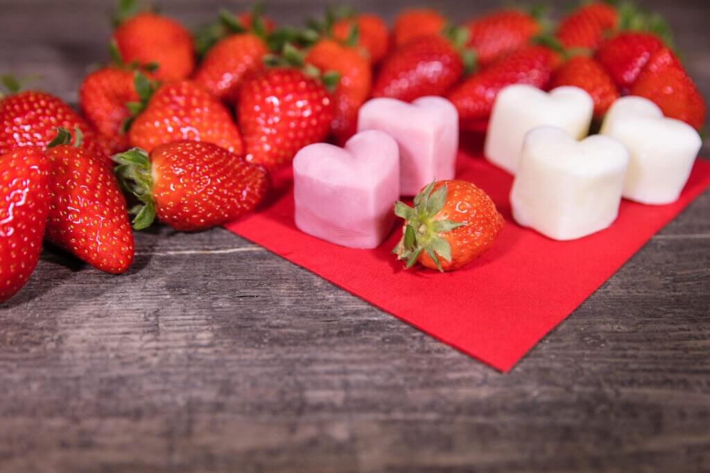 Frozen yogurt in a heart shape, Strawberries and froyo bites on wooden table