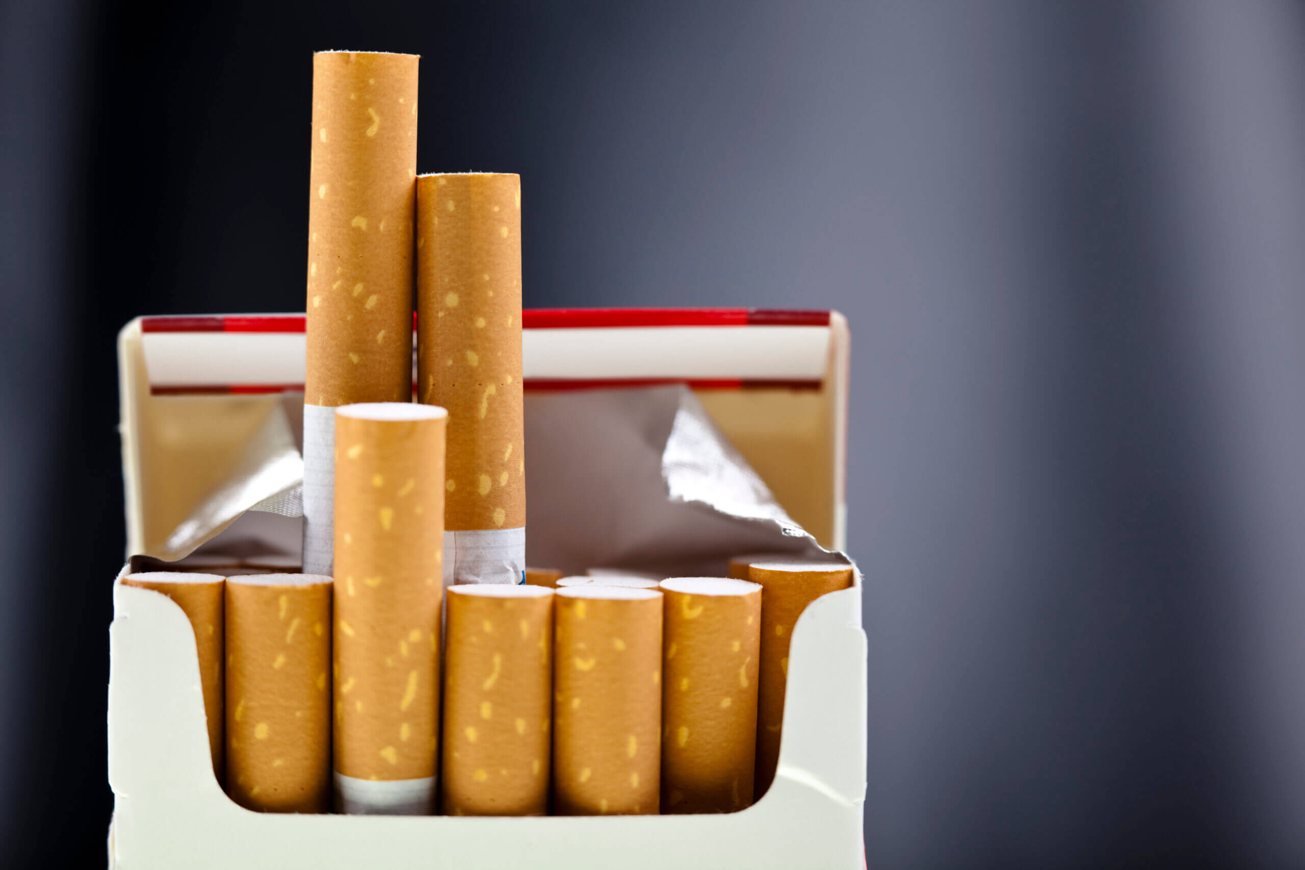 Red cigarette packet and a flat background.