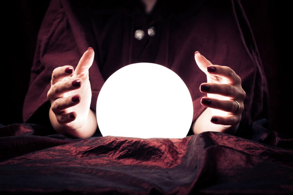 fortune teller's hands over crystal ball