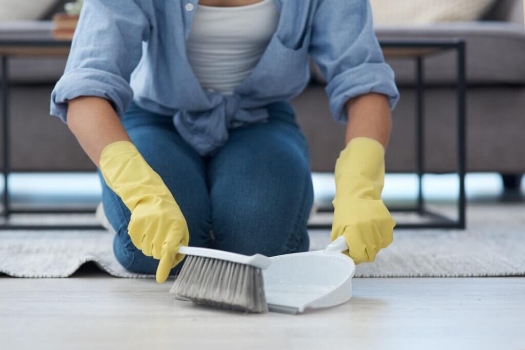 woman using dust pan