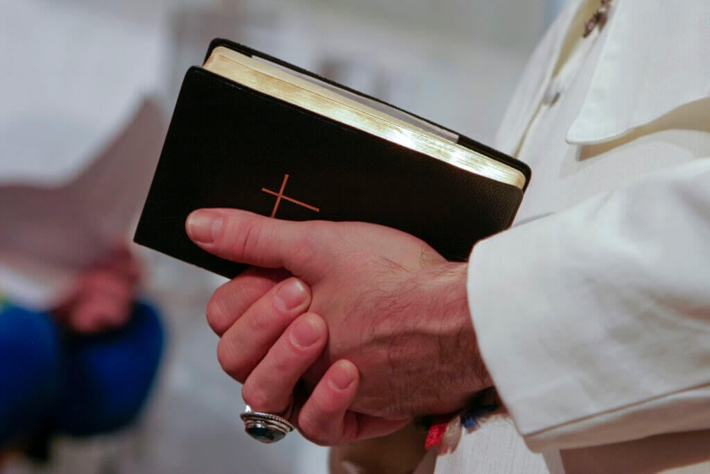 Man in popes garment holding holy bible. Adobe RGB for better color reproduction.