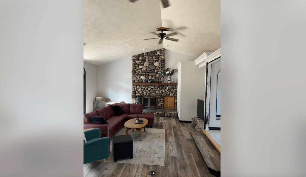 living room with stone accent wall