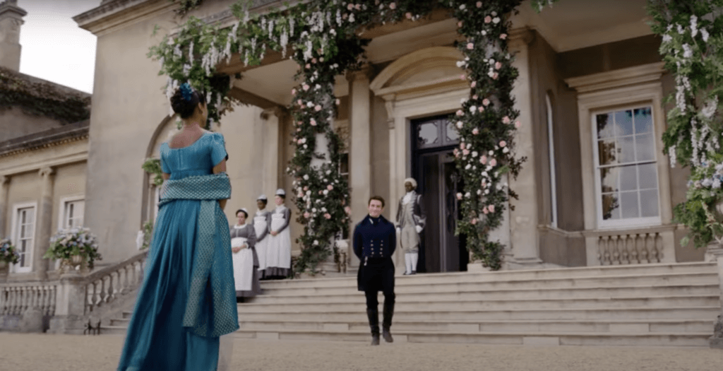 Bridgerton characters Kate and Anthony in front of Aubrey Hall