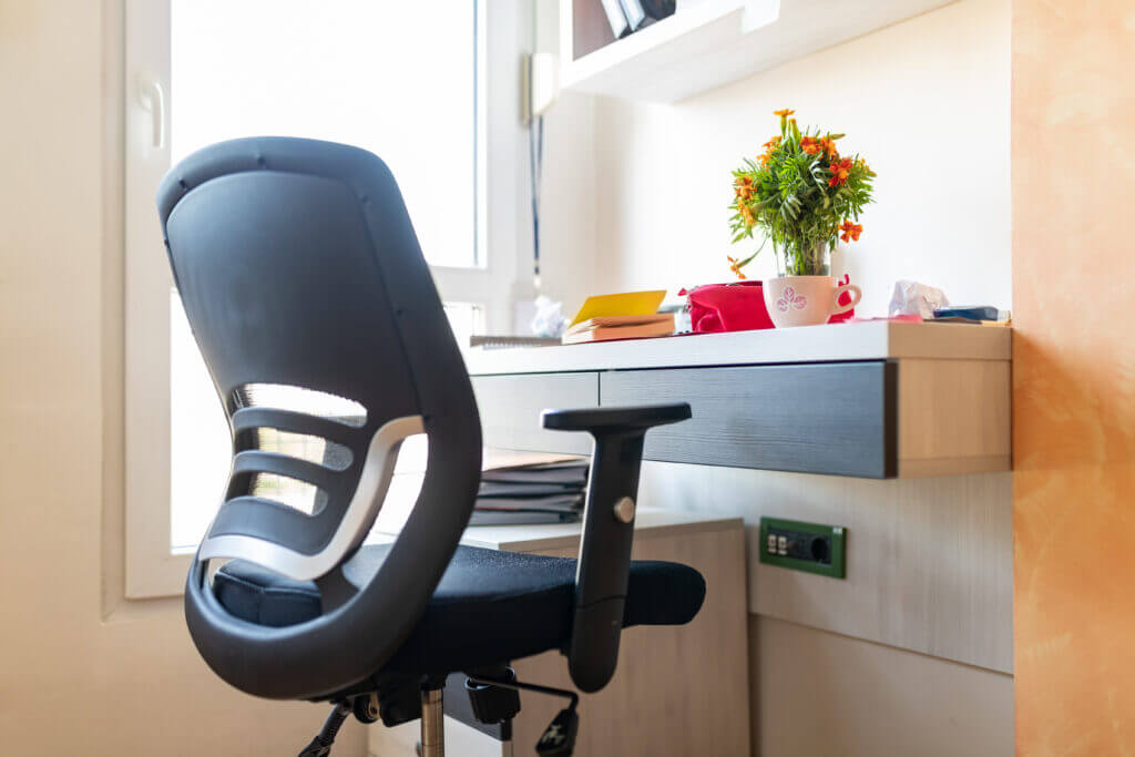 Black ergonomic office chair at the studying desk