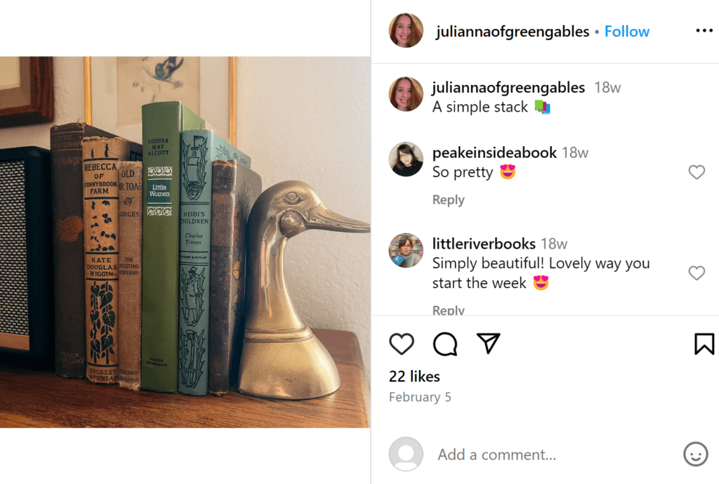 Six antique books standing on a shelf, with a single antique duck bookend on the right.