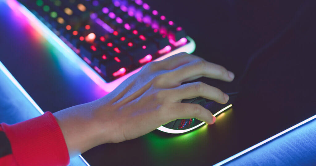 close up of pro cyber sport gamer play game with RGB keyboard and mouse