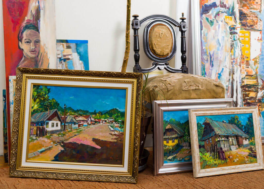 Collection of different types of handmade framed paintings in the workshop.