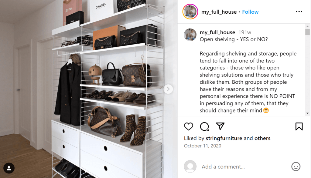 White dresser with open shelving on the top, displaying a row of designer bags, jackets, shoes, and shopping bags