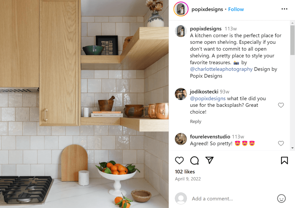 Floating shelves being used in a kitchen corner. Light wooden cabinets to the left lead into the corner shelving on the right.