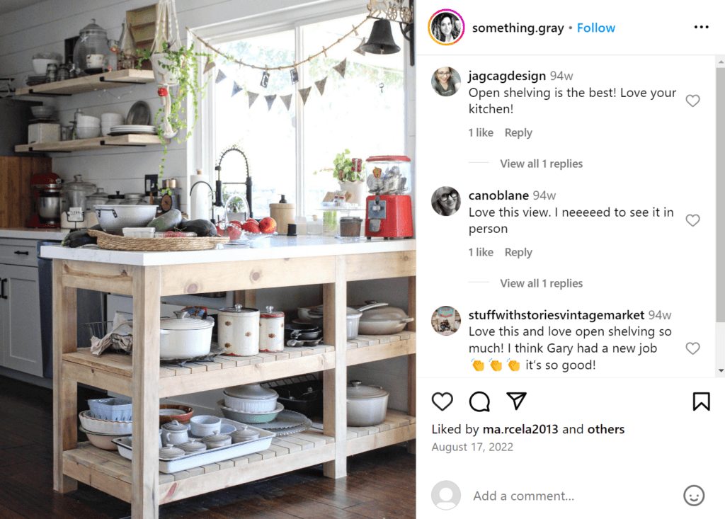 Cozy cluttered kitchen featuring counters with open shelving beneath instead of cupboard space as the kitchen island.