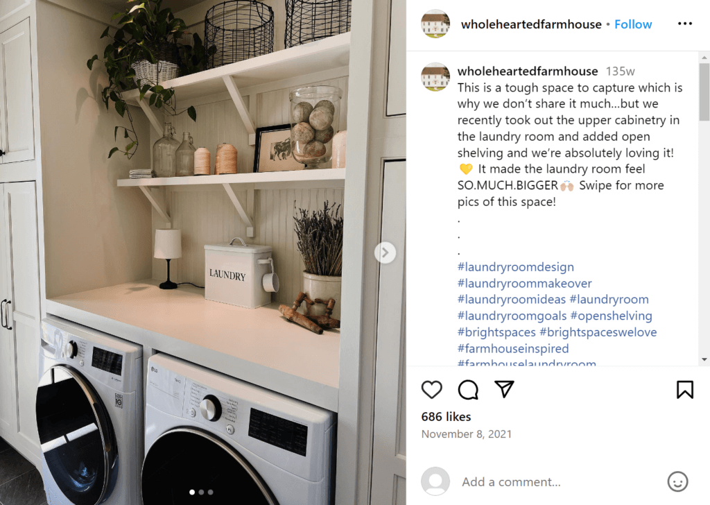 Modern laundry room with open shelving above the washer and dryer, featuring a plant, several canisters, and a metal container labeled "Laundry"