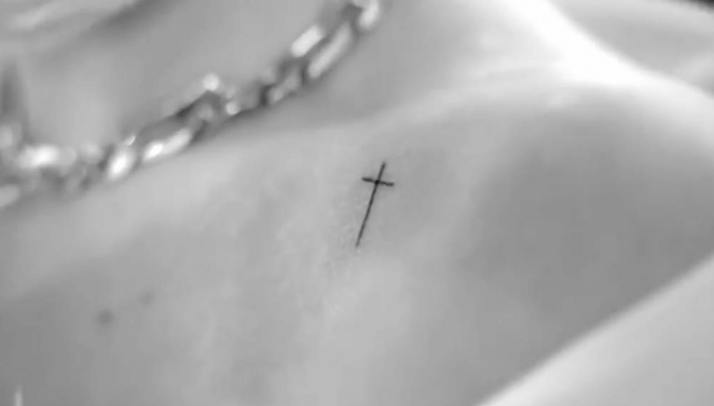 cross tattoo on selena gomez's collarbone