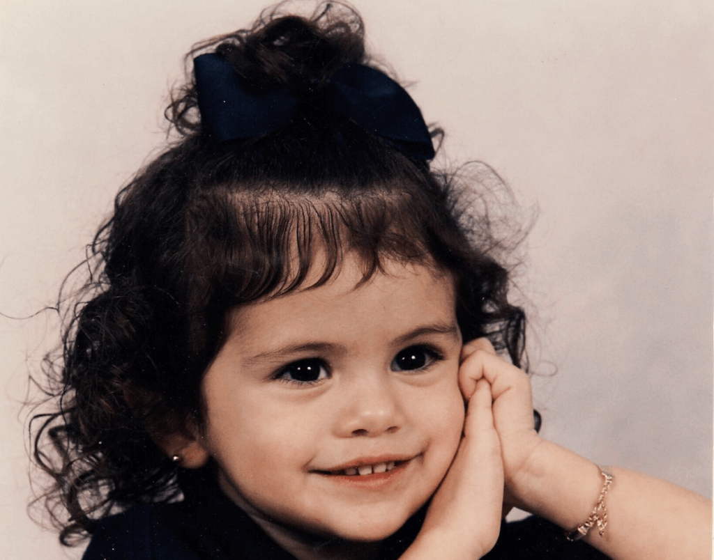 Selena Gomez smiling in a picture as a toddler