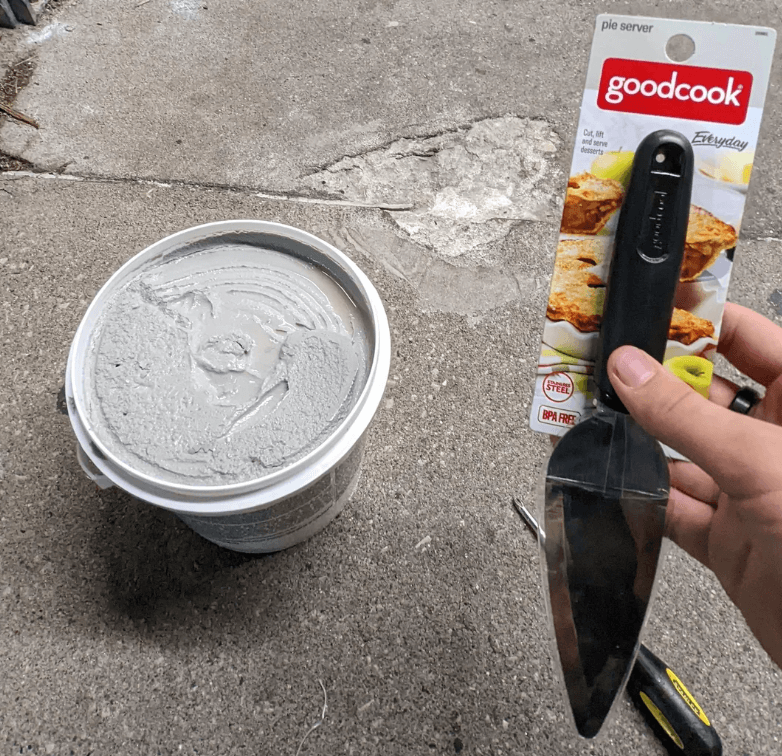 Person using a spatula as a trowel