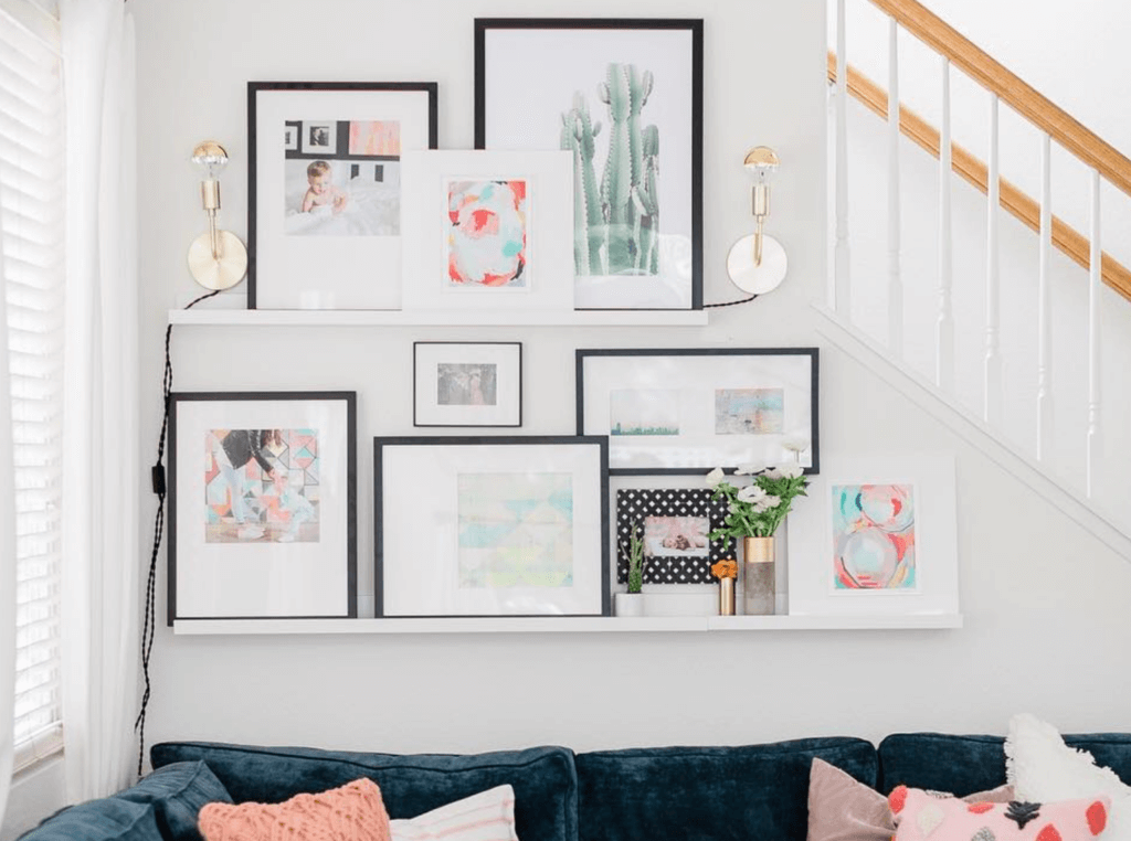 Floating shelves creating a gallery wall filled with feminine floral prints on a white wall