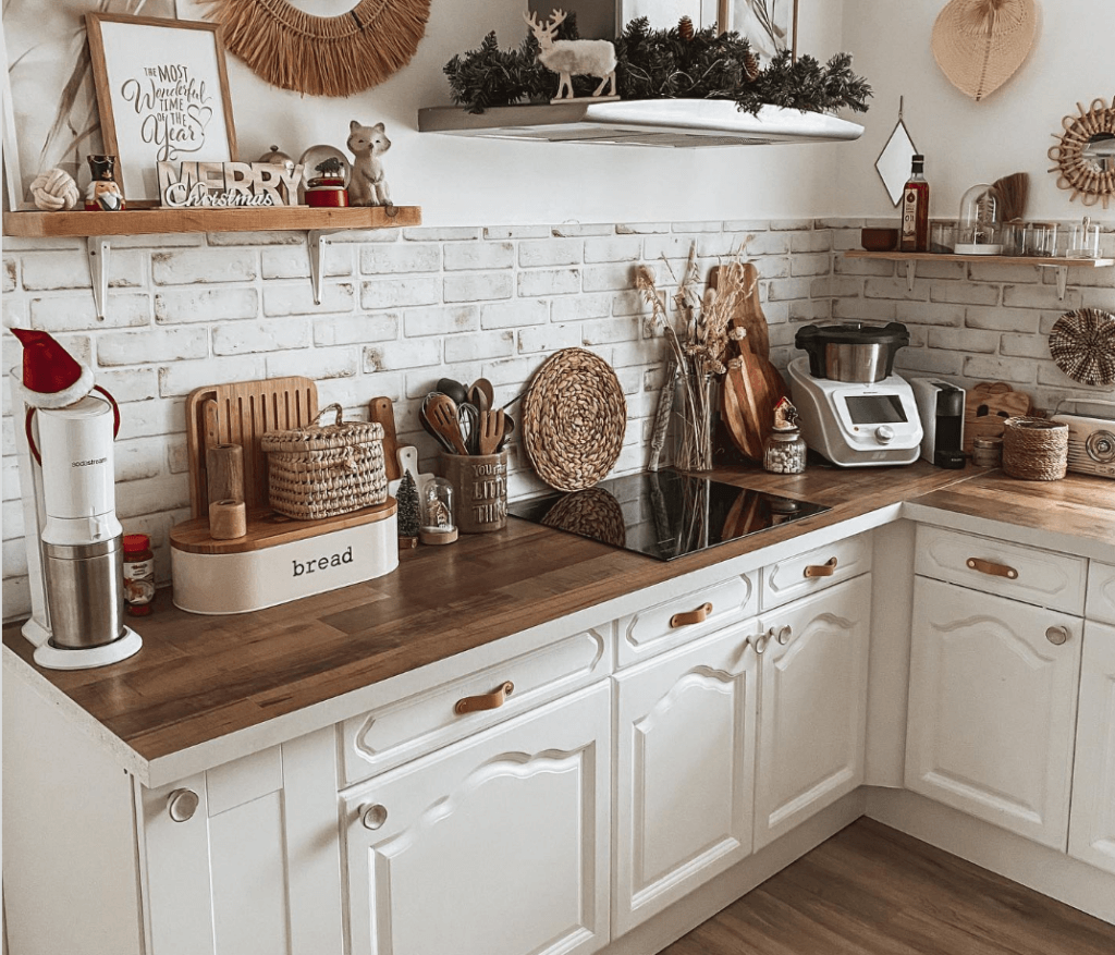 Rustic farmstyle kitchen with white cabinets featuring unique leather strap pulls