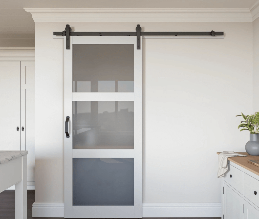 White sliding barn door on a kitchen pantry with glass panels