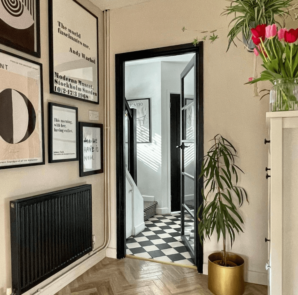 Apartment interior with a black-and-white vintage aesthetic and a painted black glass-panel interior door