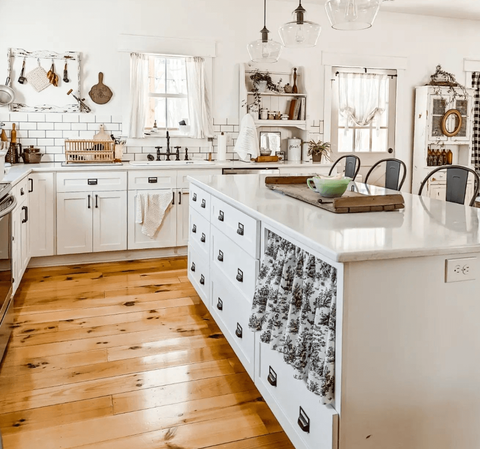 Cozy white kitchen with a black-and-white kitchen cabinet curtain