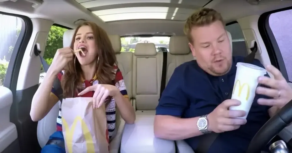 Selena Gomez and James Corden eating McDonald's in a car