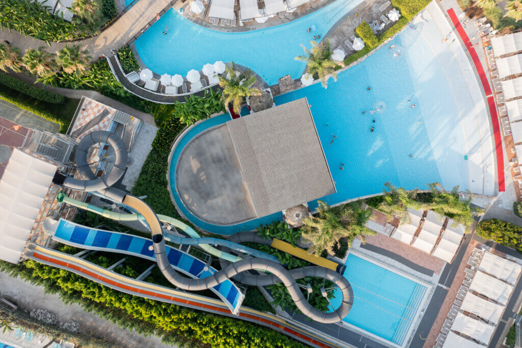 Aerial view of luxury resort hotel swimming pool, water park and sports facilities