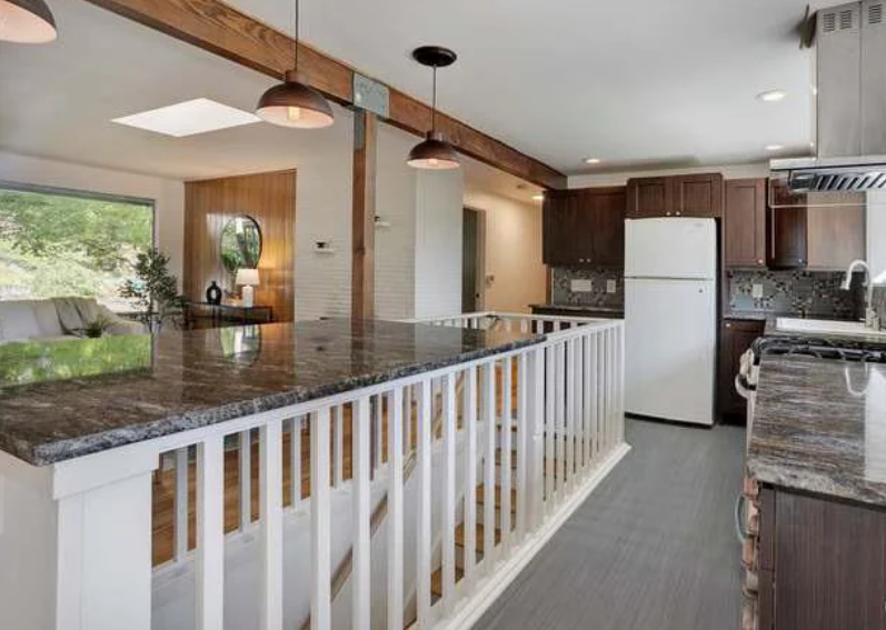 DIY fail of a kitchen counter placed above a staircase by placing it on the stair barrier