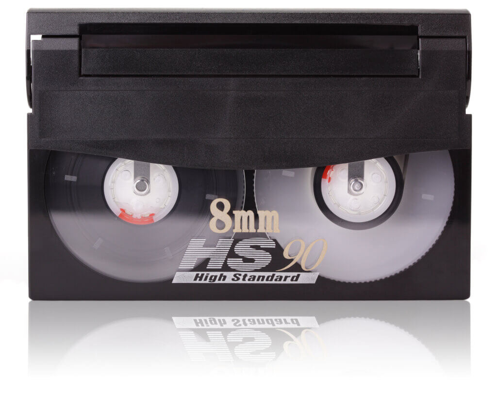 An 8mm video cassette, isolated on a white background with reflection.