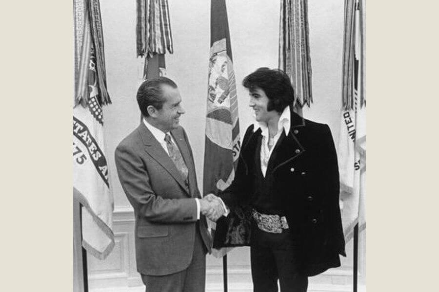 President Richard Nixon and Elvis Presley smiling and shacking hands