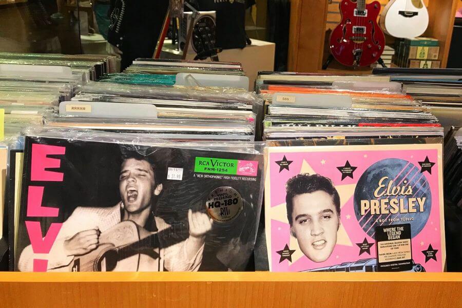 Two Elvis Presley's on a record store shelf