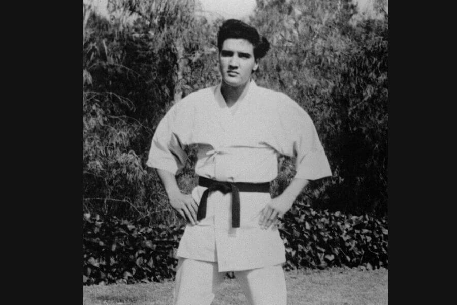 Elvis Presley in his twenties wearing a karate suit