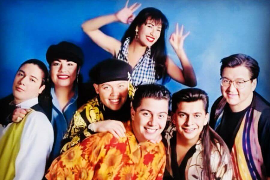 Selena Quintanilla and her band smiling at the camera