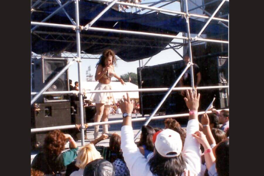 Selena waving to a crowd backstage