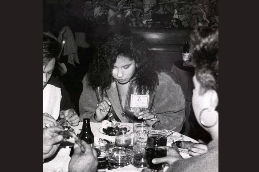 Black and white picture of Selena eating at a table