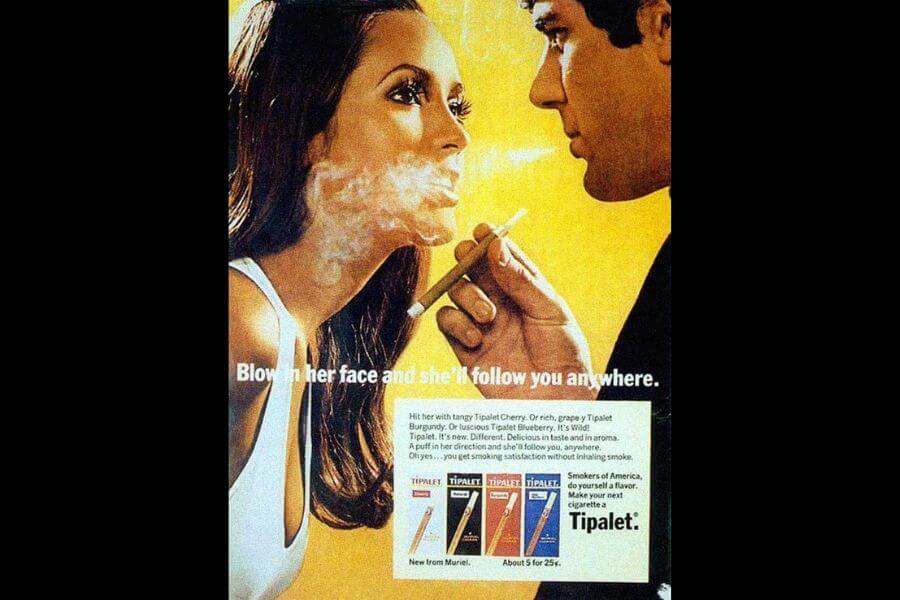 a 1970s ad of a man blowing smoke on a woman's face