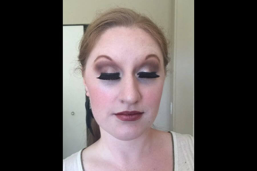 Young woman displaying an extravagant make up.