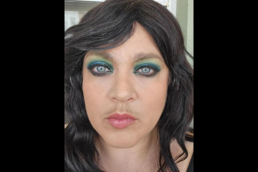 woman wearing flashy light blue eye shadow