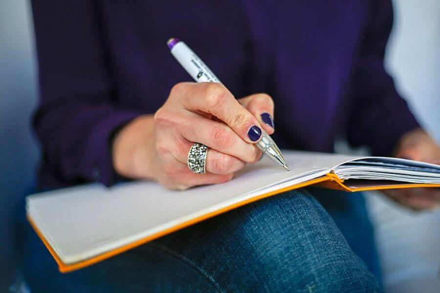 woman writing on a notebook