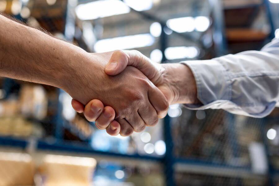 Warehouse manager hiring an employee and shaking hands