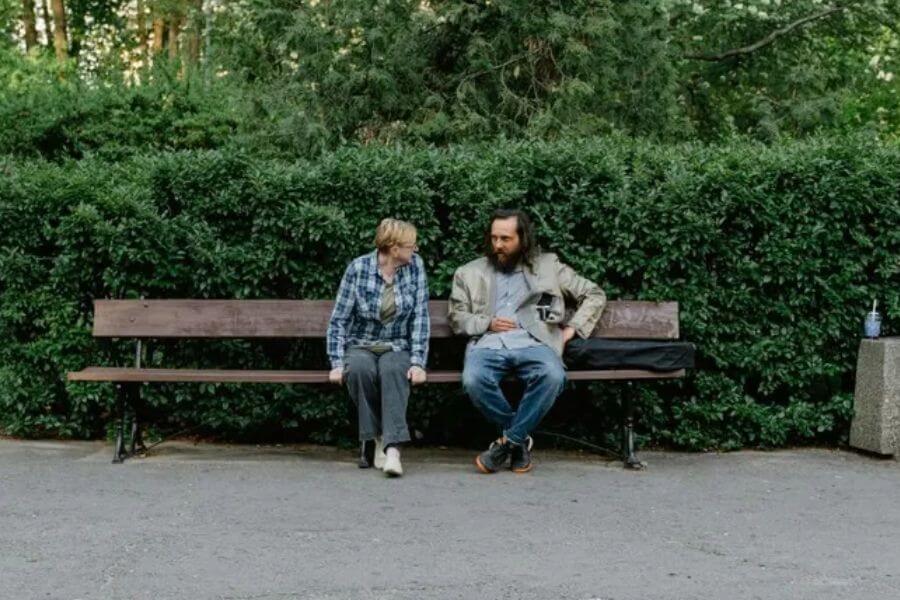 woman and man sitting on a bench