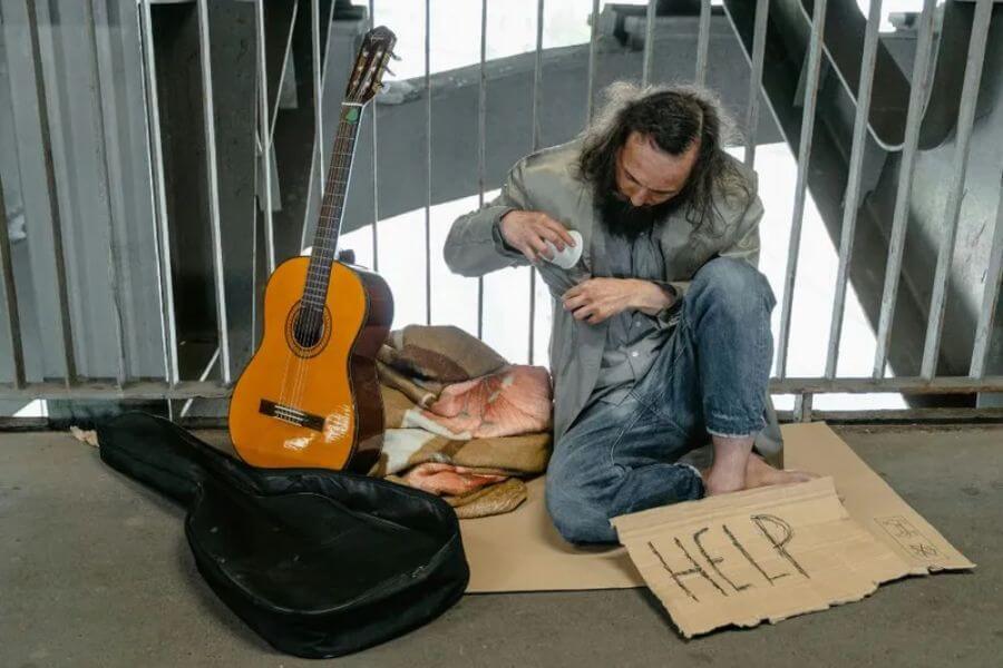 Homeleess man sitting on the floor