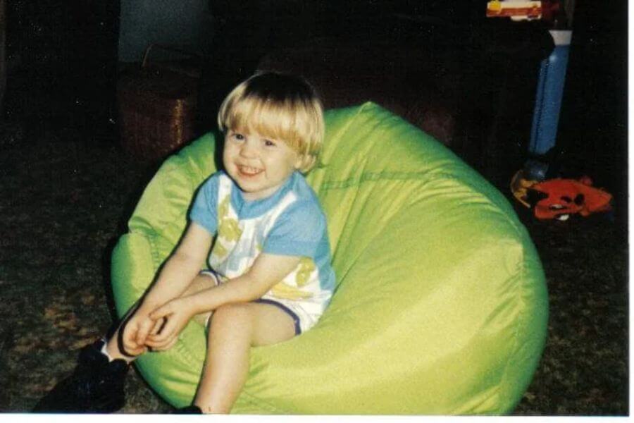 little kid sitting on bean bag chair