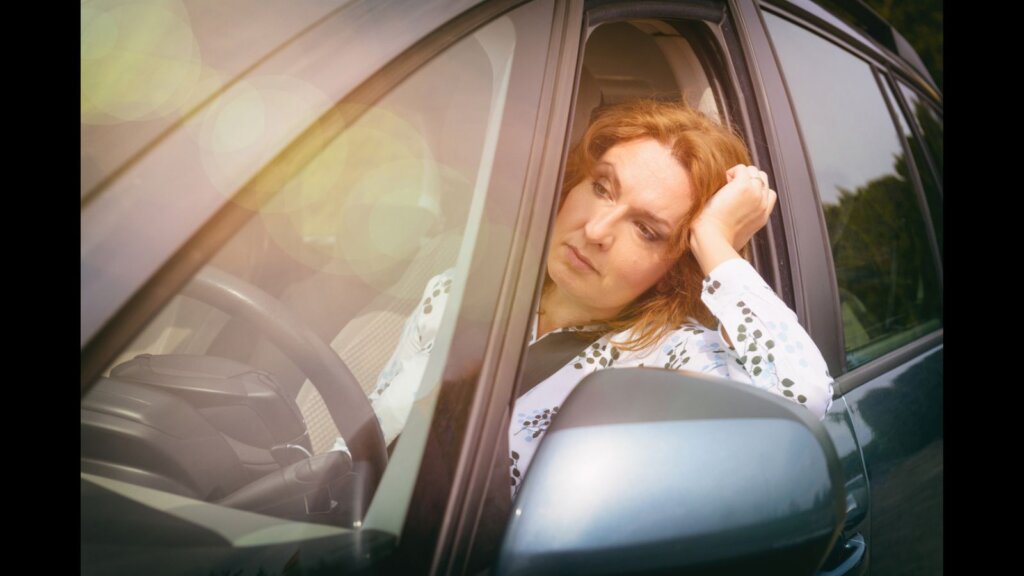 A woman thinking deep while driving. 