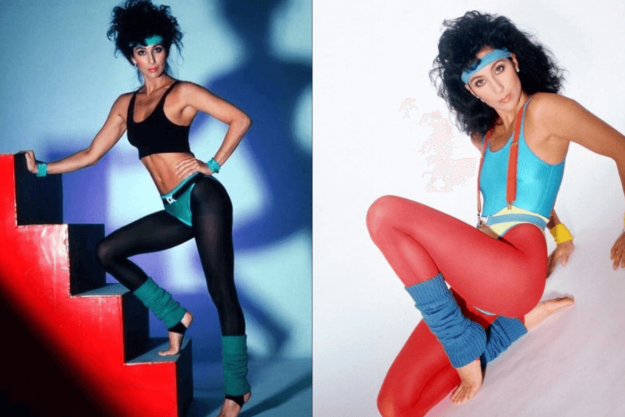 The photo features a woman in vibrant 80s fitness attire, including leggings, leotards, and leg warmers, striking dynamic poses—one stepping on red stairs and the other seated, exuding energy and retro style.