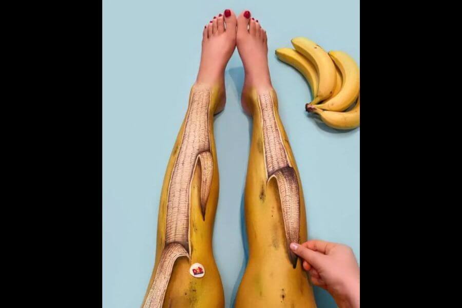 female legs painted as bananas peals