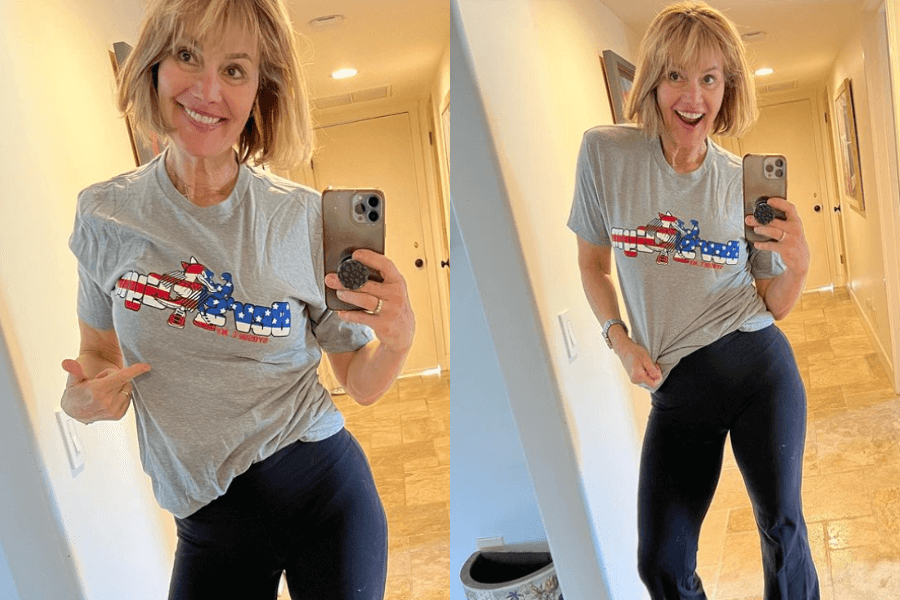 The photo shows a cheerful woman taking a selfie in a hallway, wearing a gray T-shirt with an American flag design and black leggings, pointing to her shirt in one image and smiling energetically in the other.