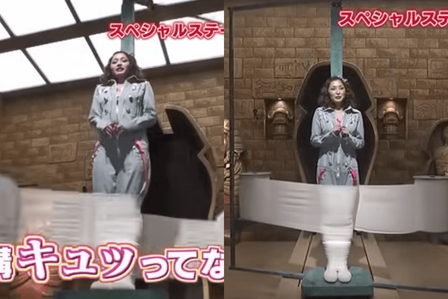 This image depicts a scene from a Japanese game show or variety show. The contestant, dressed in a gray jumpsuit with pink accents, stands in front of a wall decorated with Egyptian or ancient temple-inspired motifs. In the sequence, it appears that a mechanism is wrapping her legs tightly with bandages or cloth, giving the impression of mummification. 