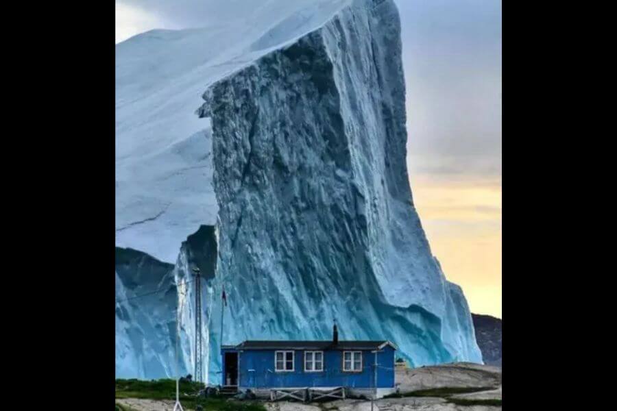 Gigantic Ice berg behind house