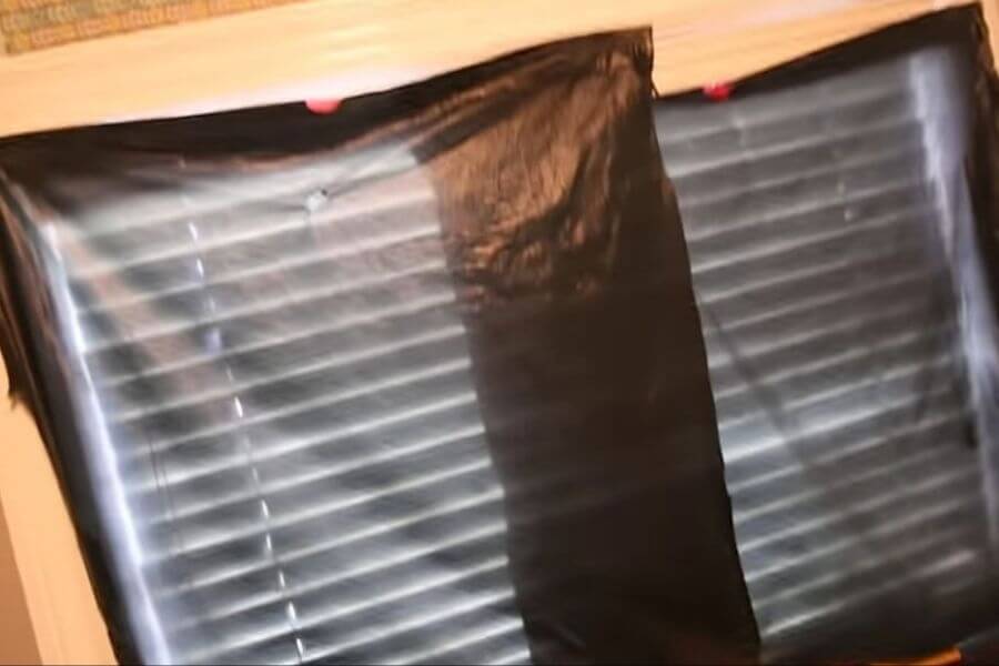 window covered with platic bags